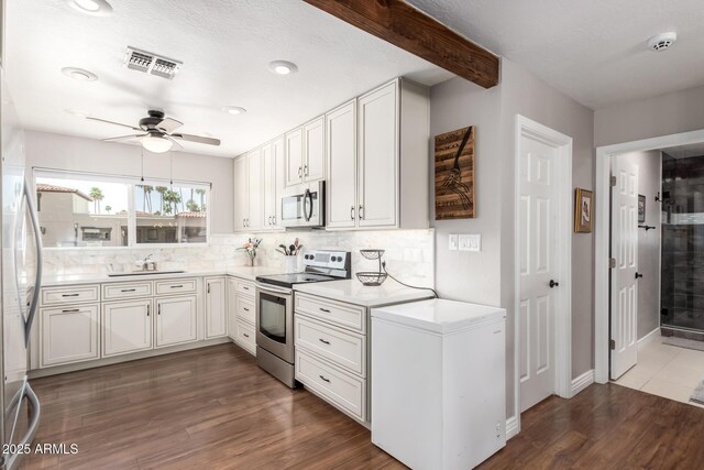7736 E Rancho Vista Dr, Scottsdale, AZ 85251 - kitchen featuring appliances with stainless steel finishes, a ceiling fan, tasteful backsplash, light countertops, and dark wood-style flooring