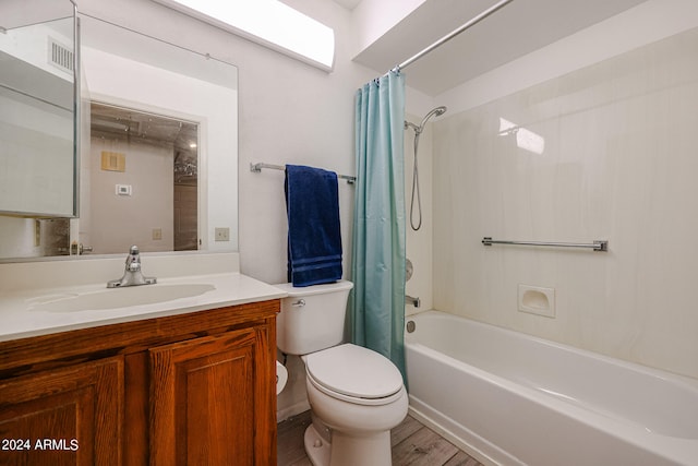 full bathroom with vanity, shower / bath combo with shower curtain, toilet, and hardwood / wood-style flooring