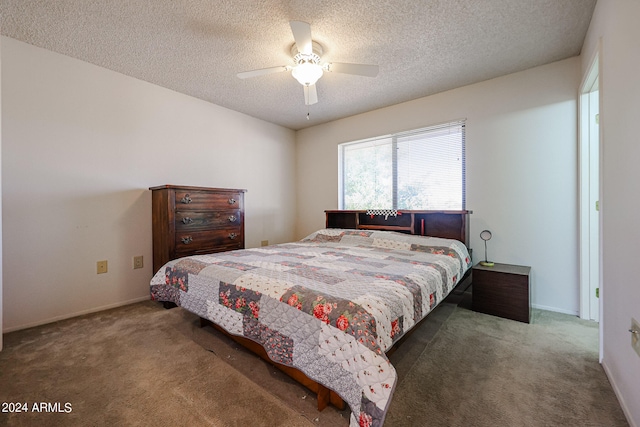 bedroom featuring ceiling fan, dark carpet, and a textured ceiling