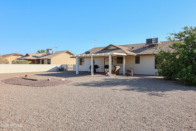 rear view of house with a patio and central air condition unit