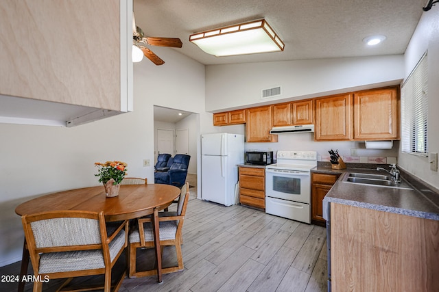 kitchen with ceiling fan, sink, white appliances, a textured ceiling, and light wood-type flooring