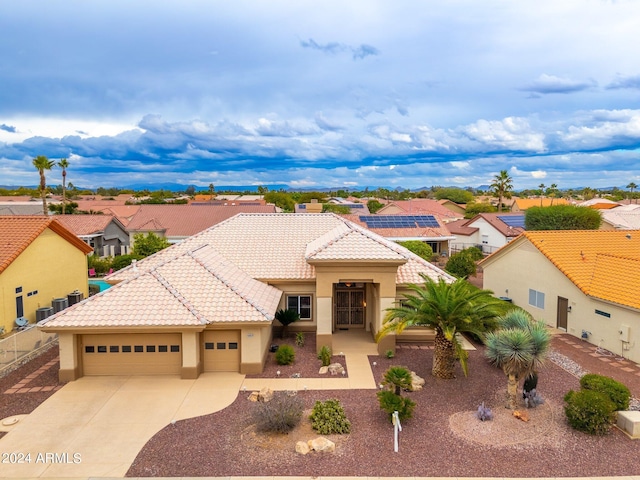 mediterranean / spanish-style home with a garage