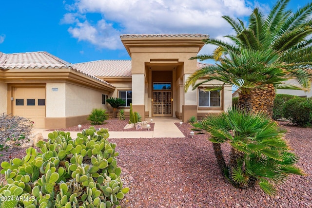 doorway to property with a garage