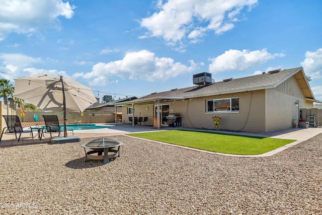 rear view of property with a fenced in pool, central AC unit, an outdoor fire pit, a patio area, and fence