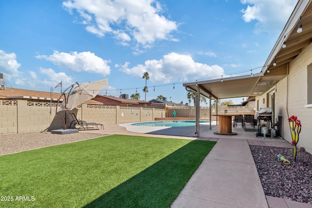 view of yard featuring a fenced backyard, a fenced in pool, and a patio