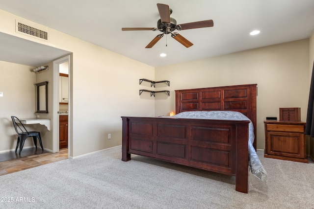 carpeted bedroom with ceiling fan, recessed lighting, visible vents, baseboards, and ensuite bath