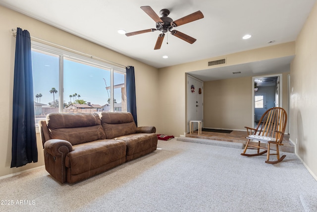 carpeted living room featuring baseboards, a ceiling fan, visible vents, and recessed lighting