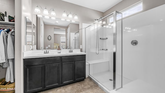 37820 W San Sisto Ave, Maricopa, AZ 85138 - bathroom featuring a walk in closet, a sink, a shower stall, and double vanity
