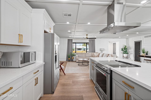 8214 E Northland Dr, Scottsdale, AZ 85251 - kitchen with stainless steel appliances, range hood, recessed lighting, open floor plan, and light wood-style floors