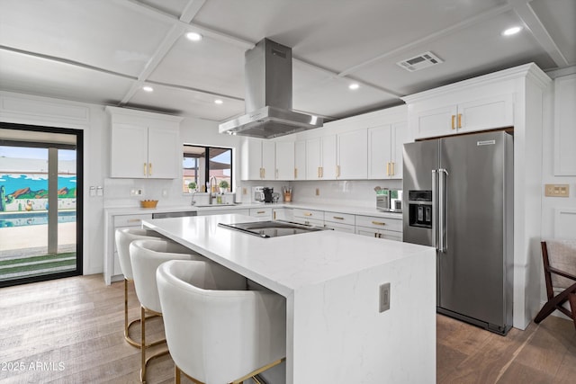 8214 E Northland Dr, Scottsdale, AZ 85251 - kitchen featuring high quality fridge, island range hood, a center island with sink, wood finished floors, and white cabinetry