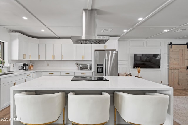 8214 E Northland Dr, Scottsdale, AZ 85251 - kitchen with high quality fridge, island range hood, light wood-style flooring, black electric stovetop, and recessed lighting