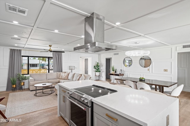 8214 E Northland Dr, Scottsdale, AZ 85251 - kitchen with electric stove, coffered ceiling, island range hood, a decorative wall, and gray cabinetry