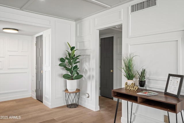 8214 E Northland Dr, Scottsdale, AZ 85251 - home office with light wood-style floors and a decorative wall