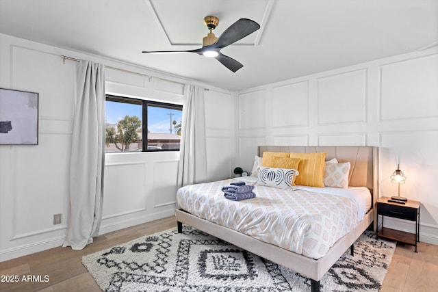 8214 E Northland Dr, Scottsdale, AZ 85251 - bedroom featuring a decorative wall, light wood-type flooring, and ceiling fan