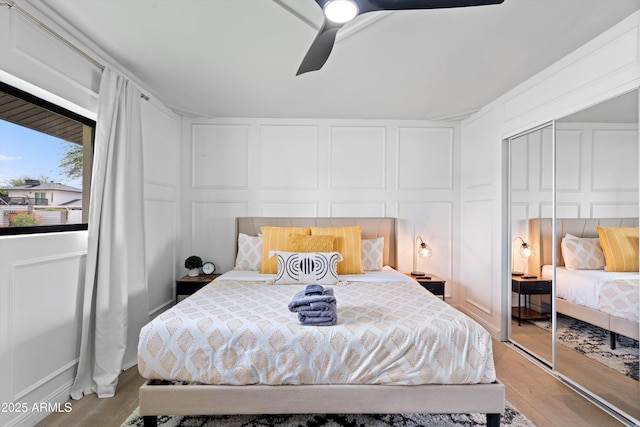 8214 E Northland Dr, Scottsdale, AZ 85251 - bedroom with a decorative wall, wood finished floors, a closet, and ceiling fan