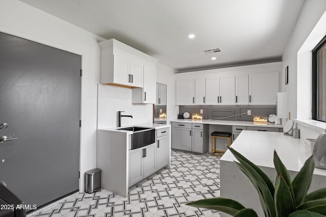 8214 E Northland Dr, Scottsdale, AZ 85251 - kitchen with light flooring, a sink, light countertops, white cabinets, and recessed lighting