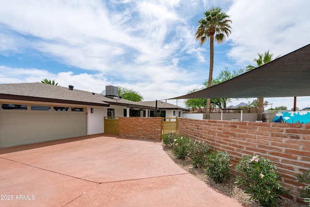 8214 E Northland Dr, Scottsdale, AZ 85251 - view of home's exterior with central air condition unit, driveway, an attached garage, and stucco siding