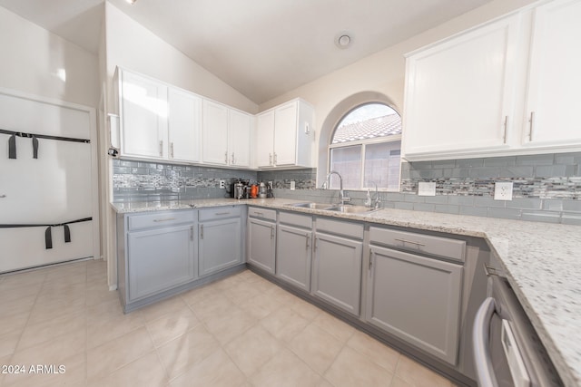 kitchen featuring lofted ceiling, white cabinets, gray cabinetry, and sink