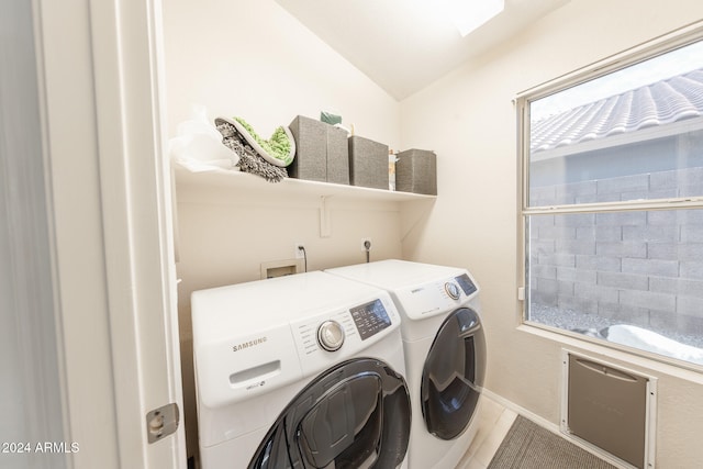 washroom with washing machine and clothes dryer and hardwood / wood-style flooring