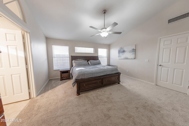 bedroom featuring lofted ceiling, light carpet, and ceiling fan