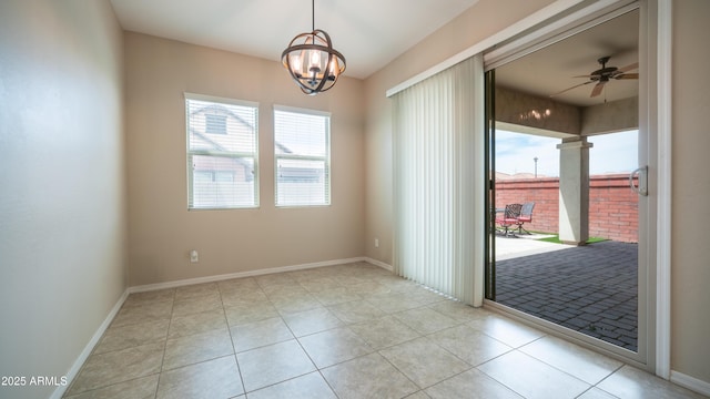 unfurnished room with light tile patterned floors, baseboards, and ceiling fan with notable chandelier