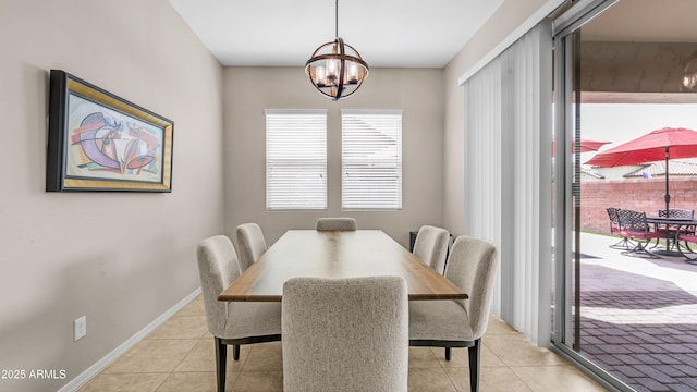 dining room featuring light tile patterned flooring, a chandelier, and baseboards
