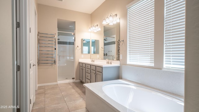 full bath with a stall shower, a garden tub, tile patterned flooring, and double vanity