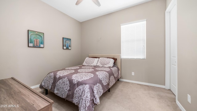 carpeted bedroom featuring baseboards and ceiling fan
