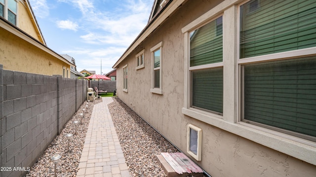 view of property exterior featuring a fenced backyard and stucco siding