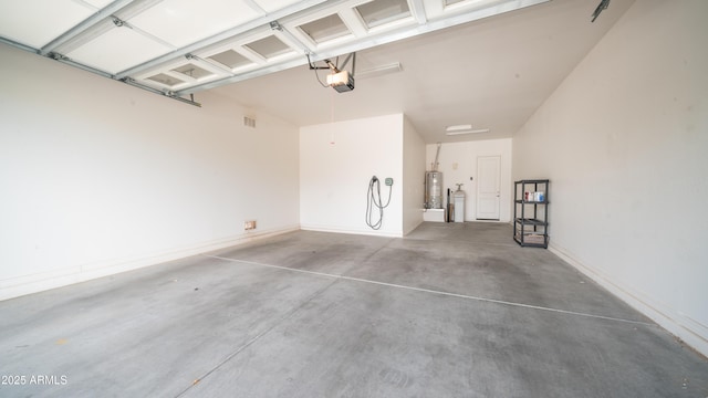 garage featuring a garage door opener and water heater
