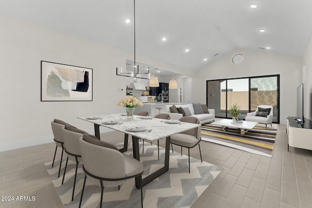 dining area with high vaulted ceiling, wood tiled floor, baseboards, and recessed lighting