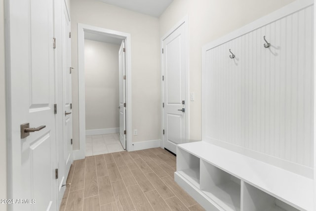 mudroom featuring wood finish floors and baseboards