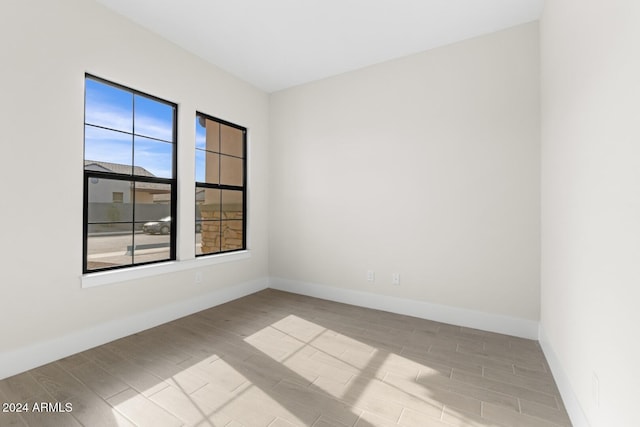 empty room featuring wood finish floors and baseboards