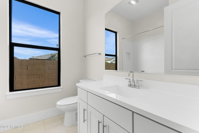 bathroom featuring tile patterned flooring, plenty of natural light, vanity, and toilet