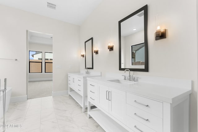full bathroom featuring two vanities, a sink, visible vents, baseboards, and marble finish floor