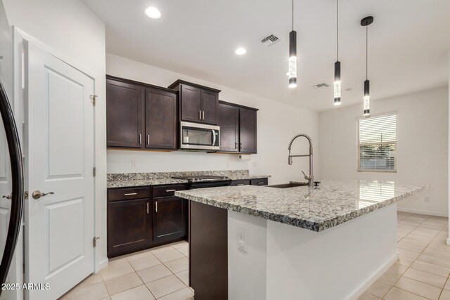 2792 E James Ave, San Tan Valley, AZ 85143 - kitchen featuring decorative light fixtures, light tile patterned floors, stainless steel appliances, a sink, and light stone counters