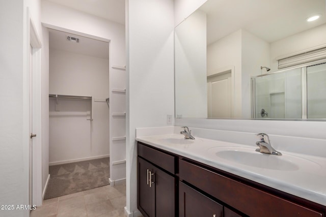 2792 E James Ave, San Tan Valley, AZ 85143 - full bath featuring a sink, a walk in closet, visible vents, and a shower stall