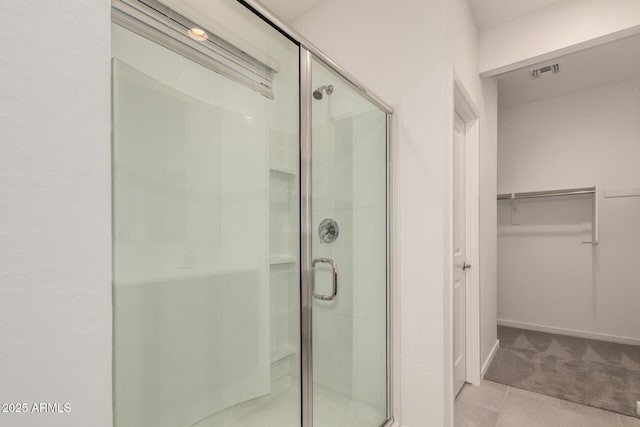 2792 E James Ave, San Tan Valley, AZ 85143 - bathroom with a shower stall, baseboards, visible vents, and a walk in closet