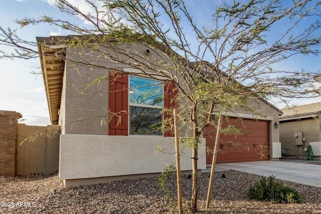 2792 E James Ave, San Tan Valley, AZ 85143 - view of side of property featuring a garage, driveway, stucco siding, and fence