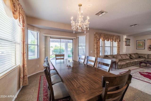 tiled dining area featuring a notable chandelier