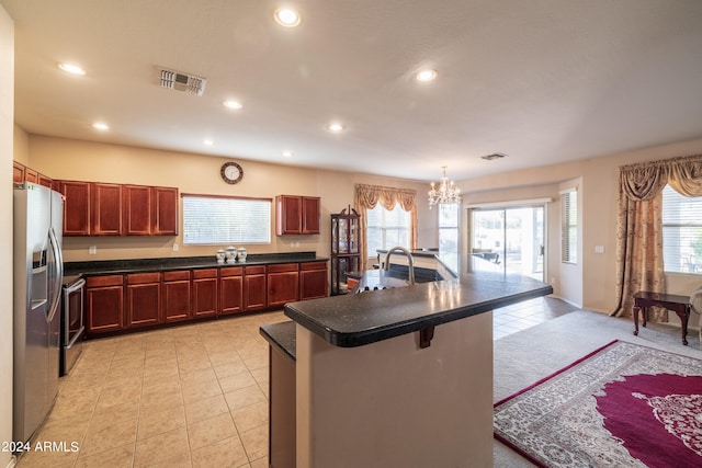 kitchen featuring a breakfast bar area, an inviting chandelier, stainless steel fridge, decorative light fixtures, and light colored carpet