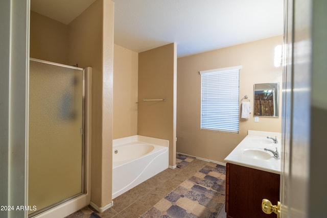 bathroom featuring vanity and independent shower and bath