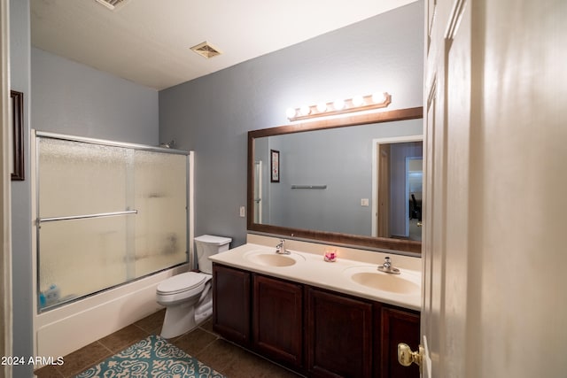 full bathroom with tile patterned floors, toilet, combined bath / shower with glass door, and vanity