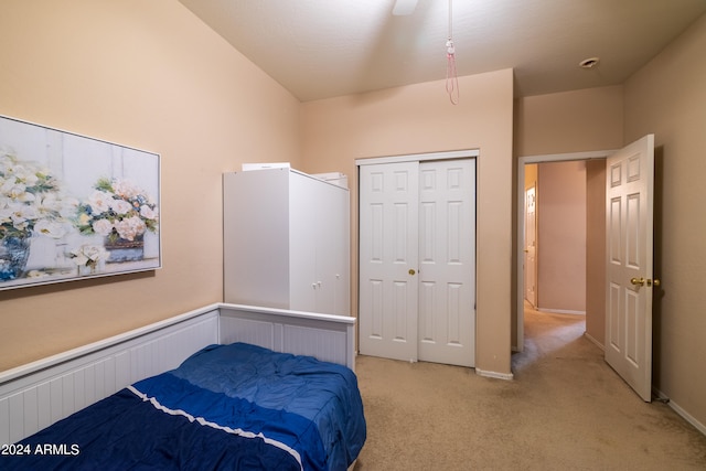 carpeted bedroom featuring ceiling fan and a closet