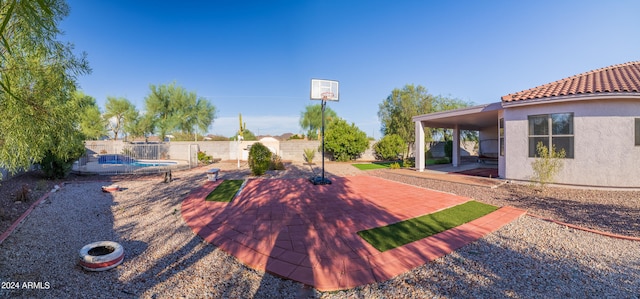 exterior space featuring a swimming pool and a patio