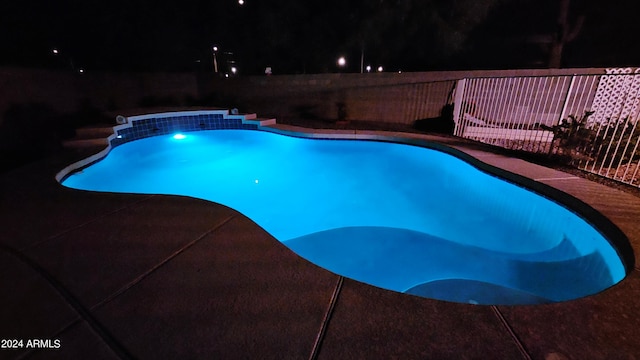 view of pool at night