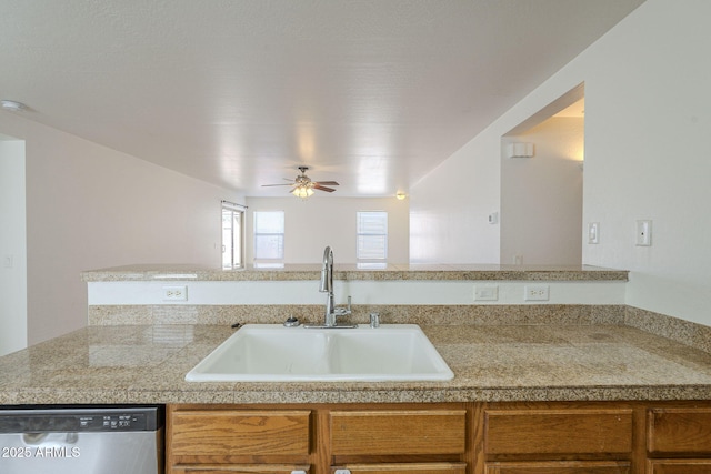 kitchen with tile counters, a ceiling fan, dishwasher, brown cabinets, and a sink