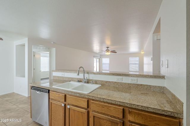 kitchen with light tile patterned floors, tile countertops, a sink, stainless steel dishwasher, and brown cabinets