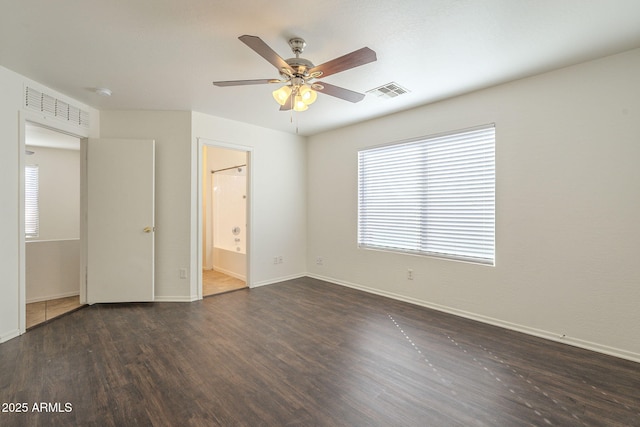 unfurnished bedroom with wood finished floors, visible vents, and baseboards