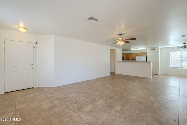 unfurnished living room featuring visible vents, ceiling fan, and light tile patterned flooring